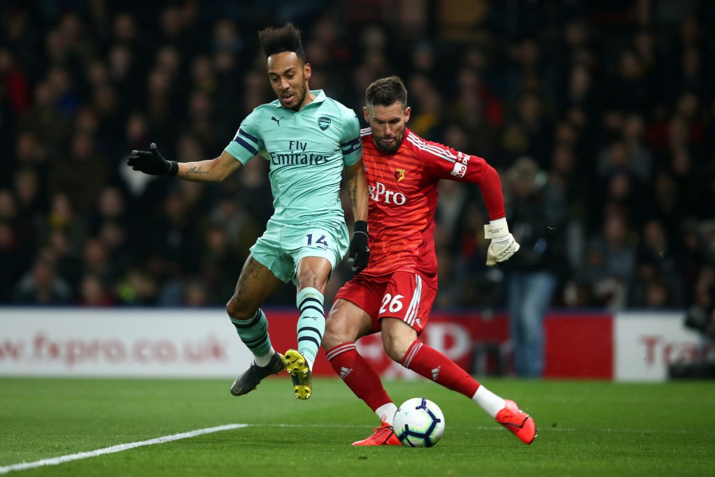 WATFORD, ENGLAND - APRIL 15: Pierre-Emerick Aubameyang of Arsenal closes down Ben Foster of Watford and scores the winning goal during the Premier ...