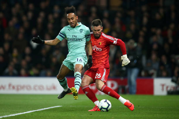 WATFORD, ENGLAND - APRIL 15: Pierre-Emerick Aubameyang of Arsenal closes down Ben Foster of Watford and scores the winning goal during the Premier ...