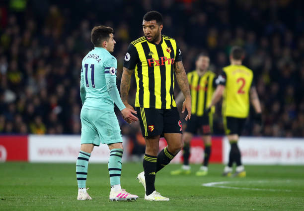 WATFORD, ENGLAND - APRIL 15: Troy Deeney of Watford talks to Lucas Torreira of Arsenal after being shown a red card for an elbow on the Arsenal pla...