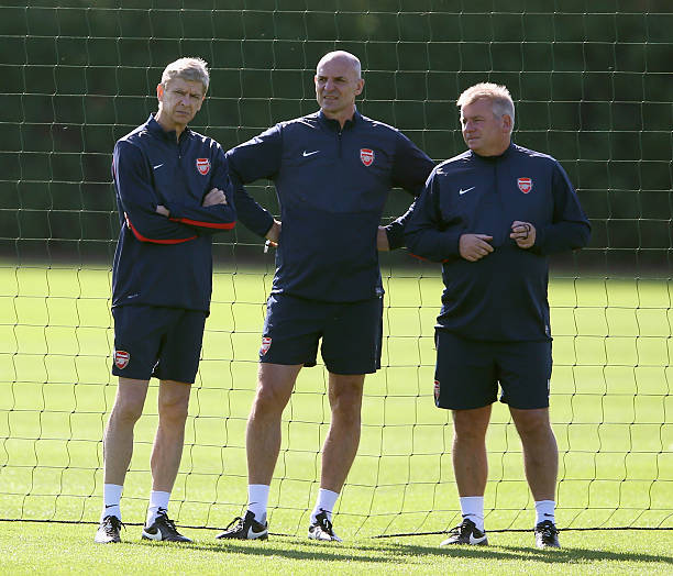 ST ALBANS, ENGLAND - AUGUST 20: Arsene Wenger, manager of Arsenal looks on with Steve Bould and Neil Banfield during a training session ahead of th...