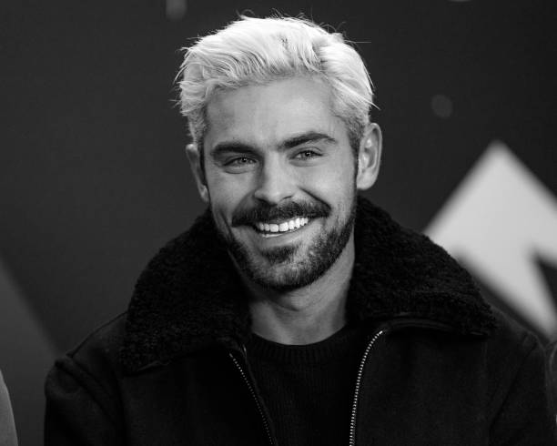 Zac Efron poses in Tottenham shirt after wearing Arsenal one 12 PARK CITY, UTAH - JANUARY 26: (EDITORS NOTE: Image has been converted to black and white.) Zac Efron of 'Extremely Wicked, Shockingly Evil and Vile...