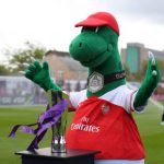 BOREHAMWOOD, ENGLAND - MAY 11: Gunnersaurus the Arsenal mascot with the Women's Super League trophy ahead of the WSL match between Arsenal Women and Manchester City at Meadow Park on May 11, 2019 in Borehamwood, England. (Photo by Catherine Ivill/Getty Images)