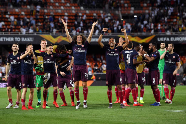 VALENCIA, SPAIN - MAY 09: Matteo Guendouzi and Pierre-Emerick Aubameyang of Arsenal celebrate victory with teammates after the UEFA Europa League S...