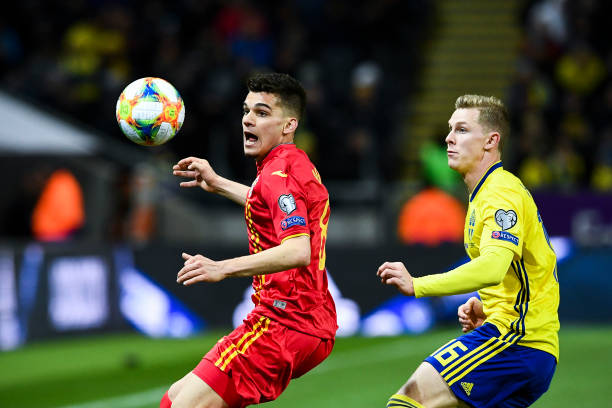 Romania's forward Ianis Hagi (L) and Sweden's defender Emil Krafth eye the ball during the Euro 2020 football 1st round Groupe F qualification matc...