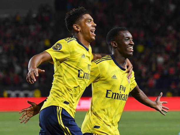 Forward Eddie Nketiah of Arsenal (R) celebrates with teammate Tyreece John-Jules (L) after scoring the winning goal against Bayern Munich during th...