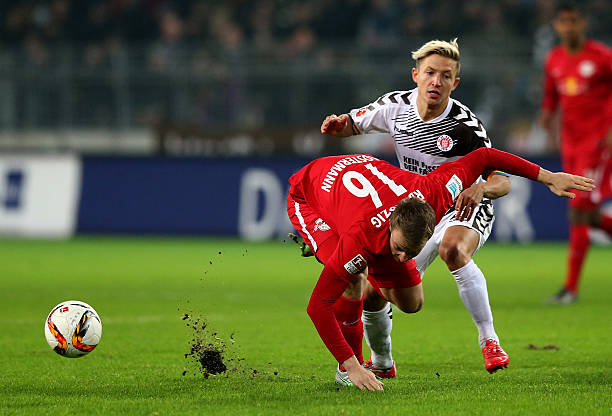 HAMBURG, GERMANY - FEBRUARY 12: Marc Rzatkowski (R) of St. Pauli challenges for the ball with Lukas Klosterman of Leipzig during the second Bundesl...