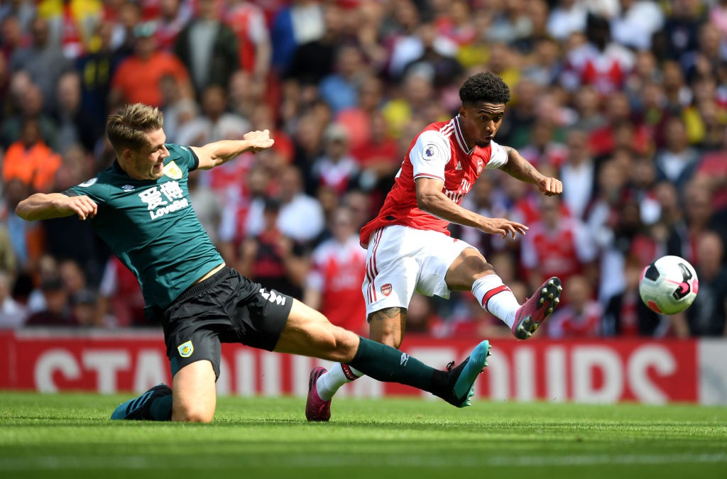 LONDON, ENGLAND - AUGUST 17: Reiss Nelson of Arsenal shoots under pressure from James Tarkowski of Burnley during the Premier League match between ...