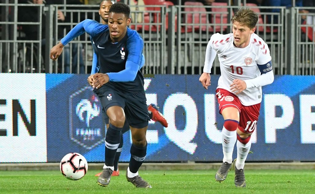 France's midfielder Jeff Reine-Adelaide (L) fights for the ball with Denmark's midfielder Mathias Jensen during the friendly U21 football match bet...