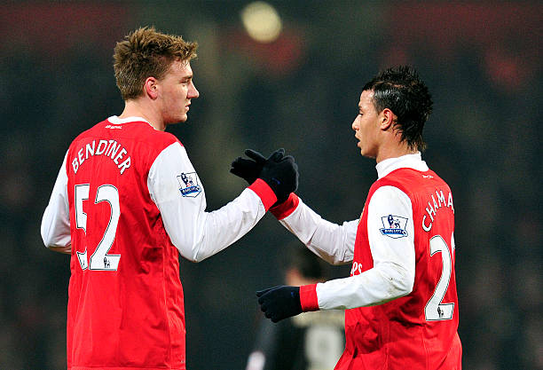 Arsenal's Danish striker Nicklas Bendtner (L) celebrates scoring the second goal with Moroccan striker Marouane Chamakh (R) during their FA Cup fif...