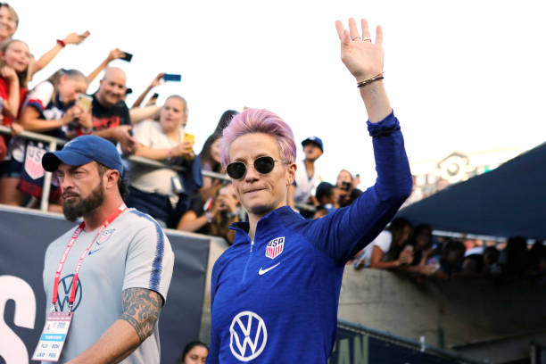 PASADENA, CALIFORNIA - AUGUST 03: Megan Rapinoe #15 of United States waves to fans as she takes the field ahead of the first game of the USWNT Vict...