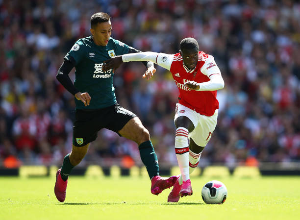 LONDON, ENGLAND - AUGUST 17: Nicolas Pepe of Arsenal is closed down by Dwight McNeil of Burnley during the Premier League match between Arsenal FC ...