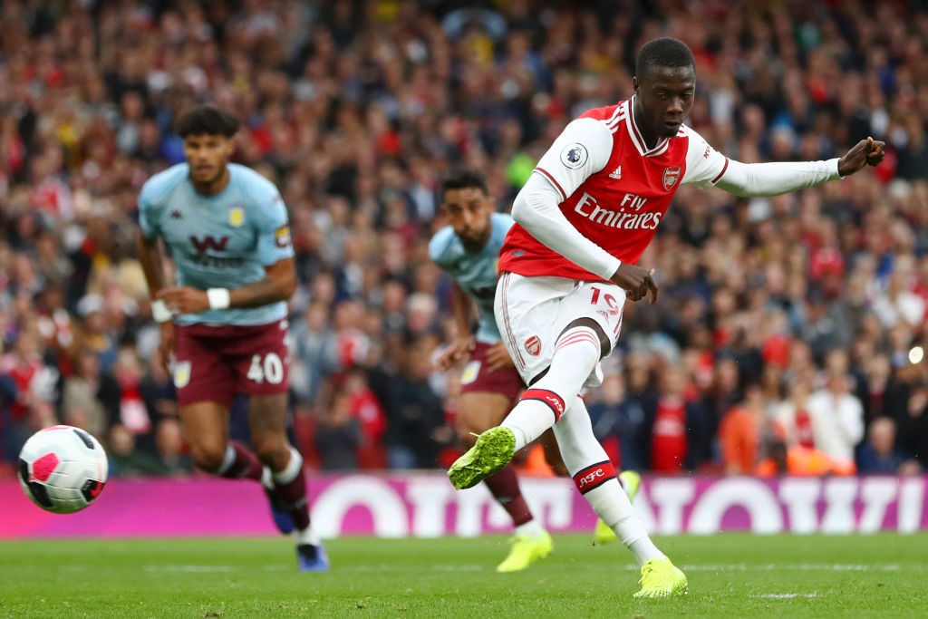 LONDON, ENGLAND - SEPTEMBER 22: Nicolas Pepe of Arsenal converts his sides penalty and scores their first goal of the game during the Premier Leagu...