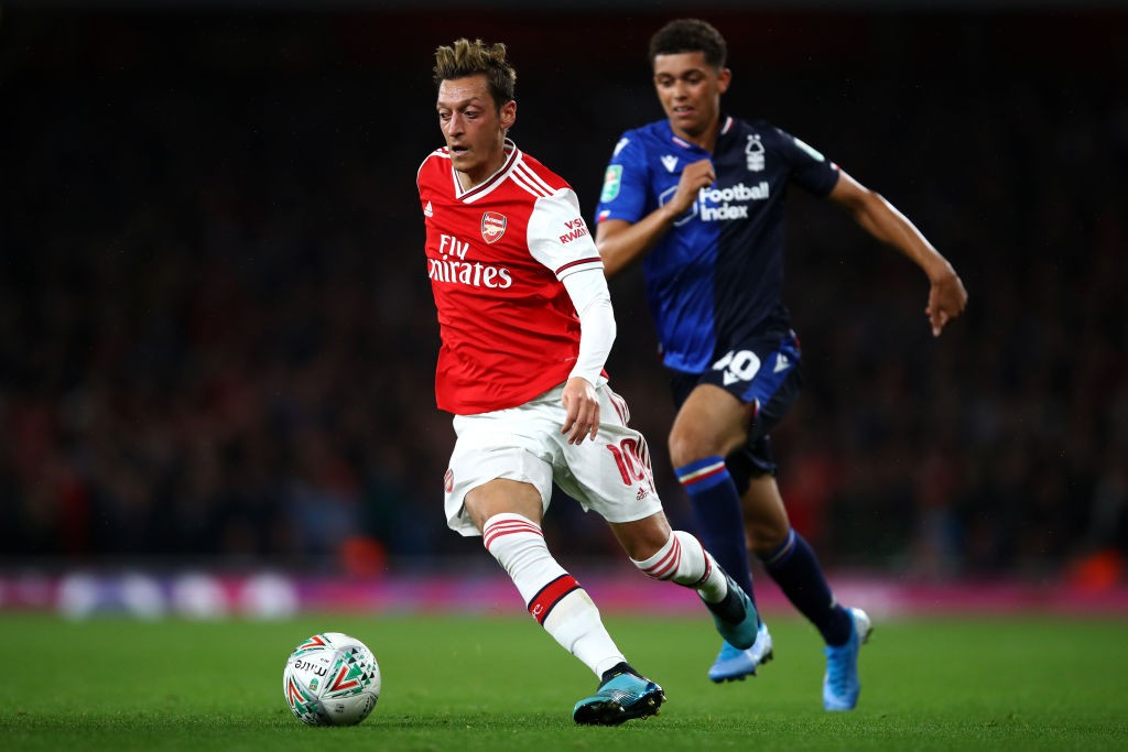 LONDON, ENGLAND - SEPTEMBER 24: Mesut Ozil of Arsenal gets past the tackle from Brennan Johnson of Nottingham Forest during the Carabao Cup Third Round match between Arsenal FC and Nottingham Forrest at Emirates Stadium on September 24, 2019, in London, England. (Photo by Julian Finney/Getty Images)