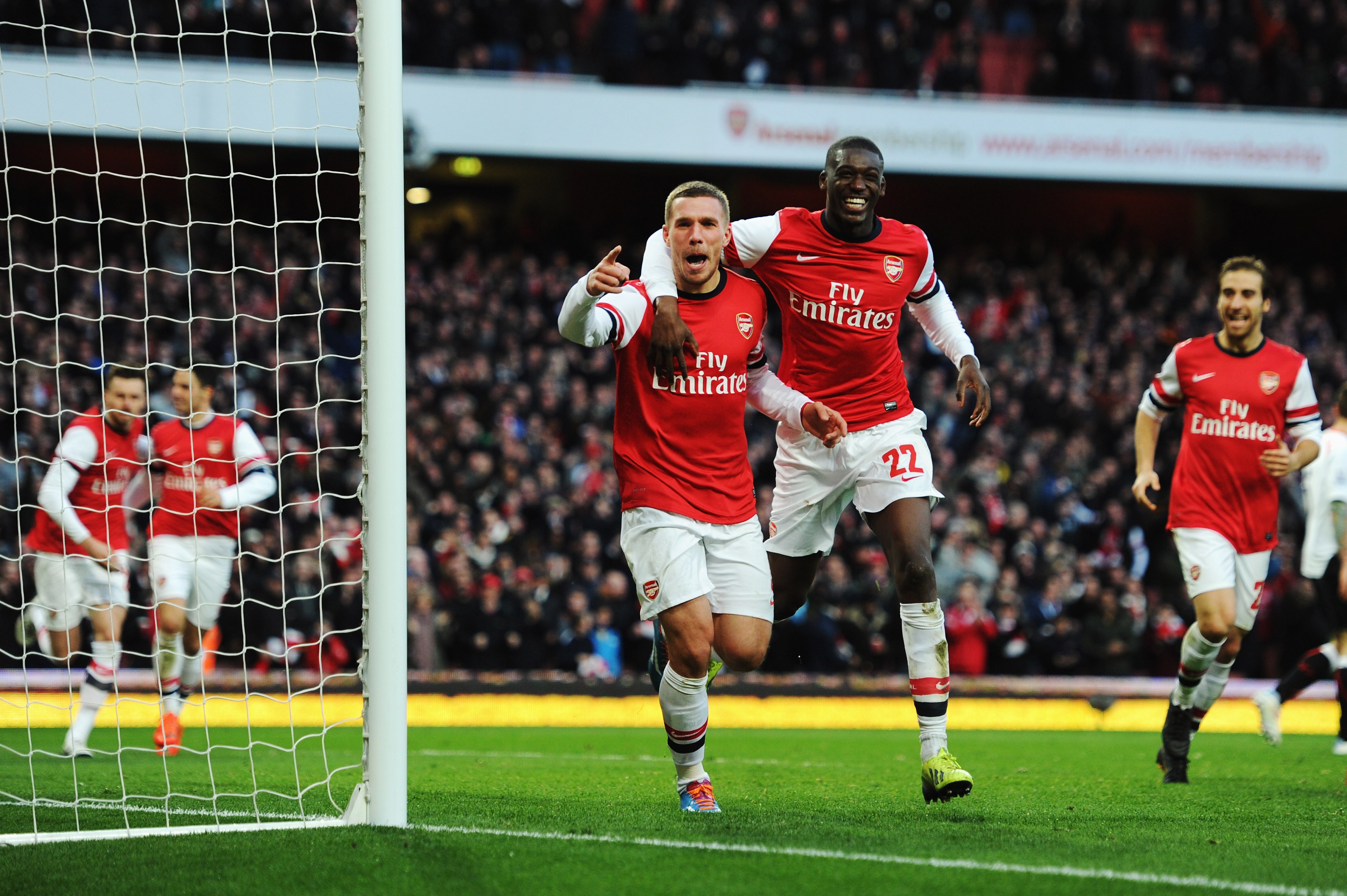 Yaya Sanogo explains why Arsene Wenger signed him 2 LONDON, ENGLAND - FEBRUARY 16: Lukas Podolski (L) of Arsenal celebrates with team mate Yaya Sanogo after scoring during the FA Cup Fifth Round match between Arsenal and Liverpool at the Emirates Stadium on February 16, 2014, in London, England. (Photo by Shaun Botterill/Getty Images)
