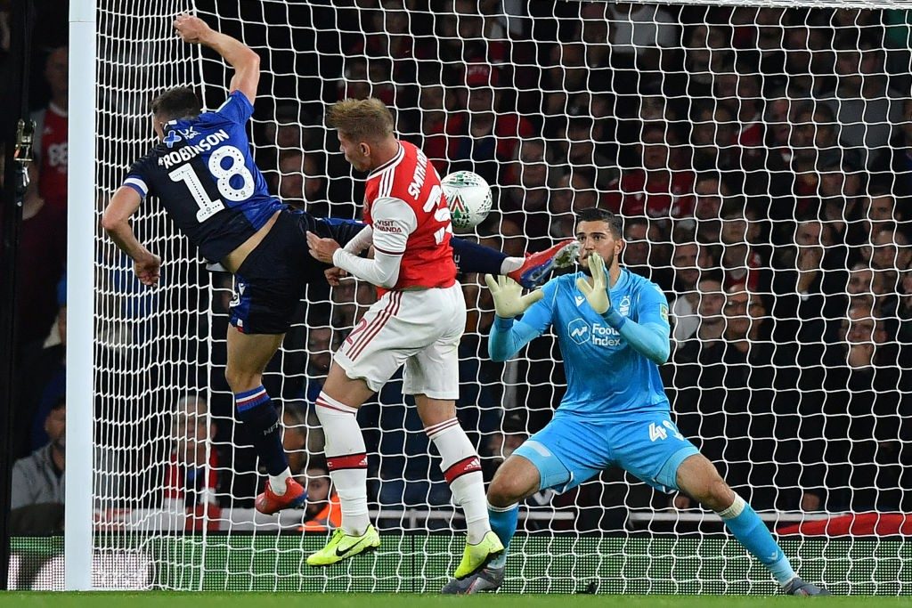 Nottingham Forest's Swiss-born Kosovan goalkeeper Arijanet Muric (R) saves a shot from Arsenal's English midfielder Emile Smith Rowe (C) as he clashes with Nottingham Forest's English defender Jack Robinson during the English League Cup third round football match between Arsenal and Nottingham Forest at the Emirates Stadium in London on September 24, 2019. (Photo by Ben STANSALL / AFP / Getty Images)