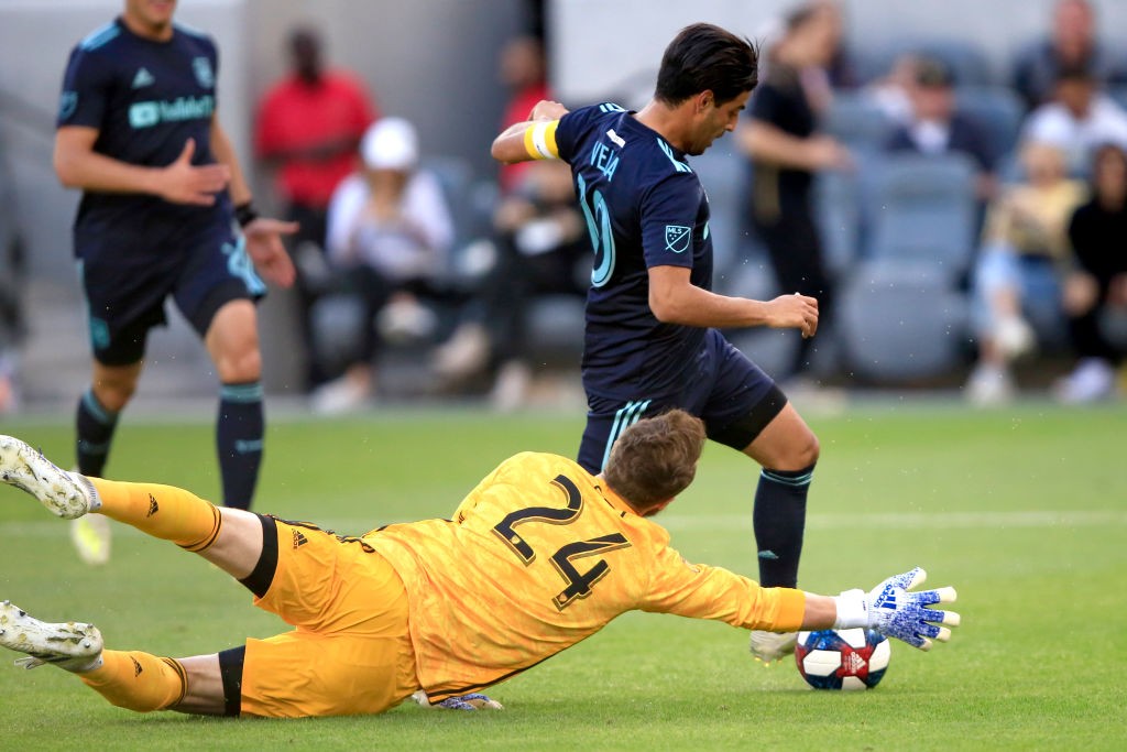 LOS ANGELES, CALIFORNIA - APRIL 21: Stefan Frei #24 of Seattle Sounders is unable to stop Carlos Vela #10 of Los Angeles FC as he scores a goal dur...