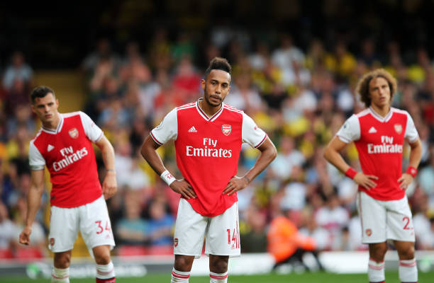 WATFORD, ENGLAND - SEPTEMBER 15: Pierre-Emerick Aubameyang of Arsenal (14) and team mates Granit Xhaka and David Luiz react during the Premier Leag...