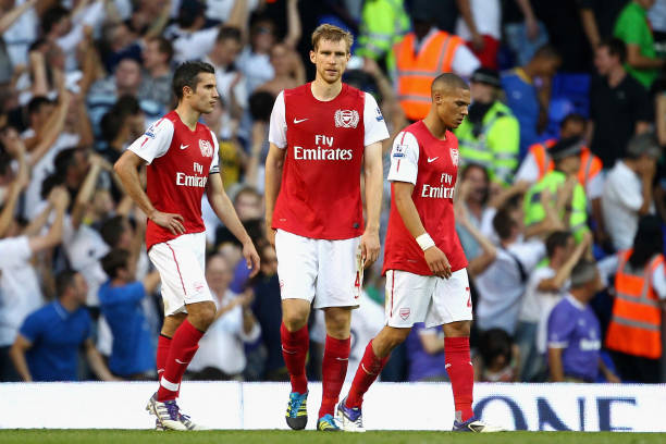 LONDON, ENGLAND - OCTOBER 02: Dejected Robin van Persie, Per Mertesacker and Kieran Gibbs of Arsenal after defeat in the Barclays Premier League ma...