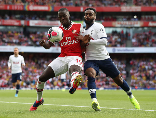 LONDON, ENGLAND - SEPTEMBER 01: Nicolas Pepe of Arsenal battle with Danny Rose of Spurs during the Premier League match between Arsenal FC and Tott...