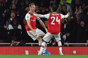 Arsenal's English defender Rob Holding (L) celebrates scoring his team's second goal during the English League Cup third round football match between Arsenal and Nottingham Forest at the Emirates Stadium in London on September 24, 2019. (Photo by Ben STANSALL / AFP)