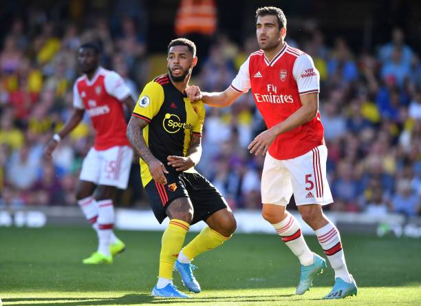 Watford's English striker Andre Gray (L) and Arsenal's Greek defender Sokratis Papastathopoulos look on during the English Premier League football ...
