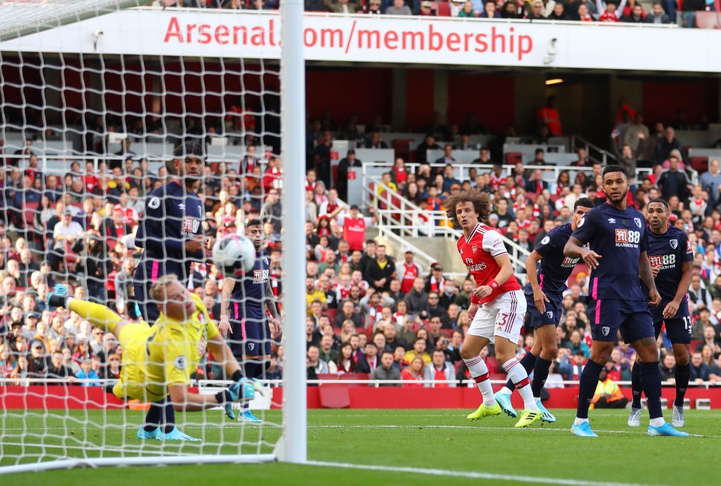 LONDON, ENGLAND - OCTOBER 06: David Luiz of Arsenal scores his team's first goal during the Premier League match between Arsenal FC and AFC Bournem...