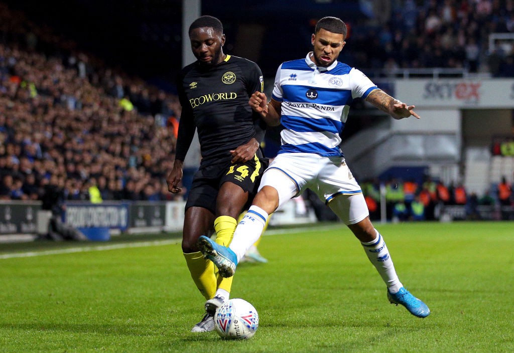 LONDON, ENGLAND - OCTOBER 28: Josh Dasilva of Brentford is challenged by Nahki Wells of Queens Park Rangers during the Sky Bet Championship match b...