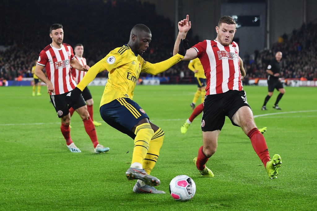 SHEFFIELD, ENGLAND - OCTOBER 21: Nicolas Pepe of Arsenal controls the ball as Jack O'Connell of Sheffield United looks on during the Premier League...