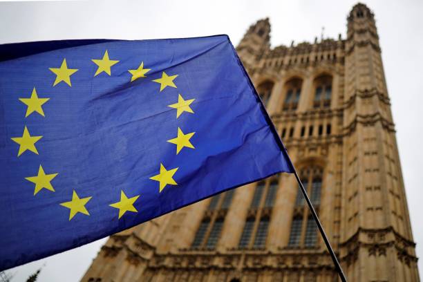 A European Union flag and belonging to an anti-Brexit activist flies outside the Houses of Parliament in London on October 23, 2019. - British Prim...