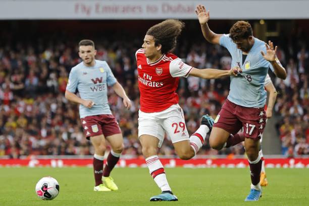 Why opposition fans hate Matteo Guendouzi and Arsenal fans love him 3 Arsenal's French midfielder Matteo Guendouzi (L) holds the shirt of Aston Villa's Egyptian midfielder Trezeguet as he runs into the penalty area during the English Premier League football match between Arsenal and Aston Villa at the Emirates Stadium in London on September 22, 2019. (Photo by Tolga AKMEN / AFP)