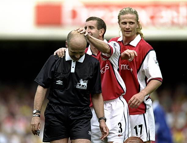 17 updates: Arsenal to raid Lille again, also reject Monaco bid 13 7 Aug 1999: Nigel Winterburn and Emmanuel Petit of Arsenal share a joke with referee Alan Wilkie during the FA Carling Premiership match against Leicester City played at Highbury in London, England. The match finished in a 2-1 win to the Arsenal. Credit: Shaun Botterill /Allsport