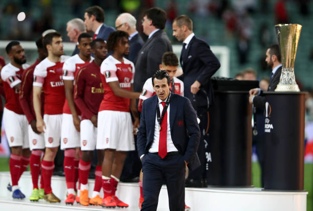 BAKU, AZERBAIJAN - MAY 29: Unai Emery, Manager of Arsenal looks dejected as he walks past the Europa League Trophy after collecting his runners up ...