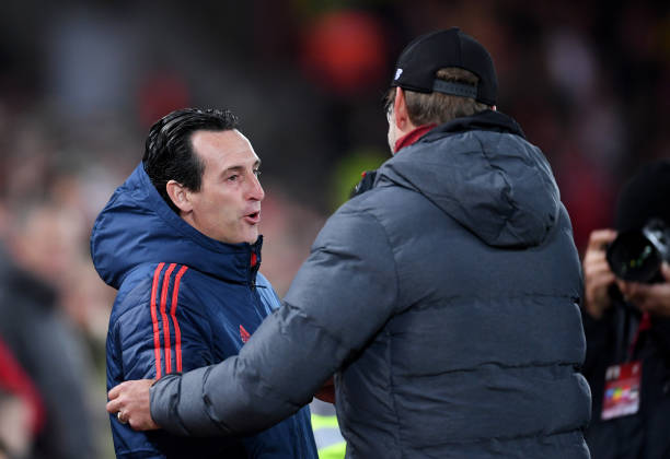 LIVERPOOL, ENGLAND - OCTOBER 30: Unai Emery, Manager of Arsenal shakes hands with Jurgen Klopp, Manager of Liverpool prior to the Carabao Cup Round...