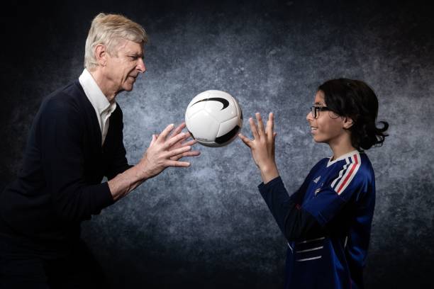Former Arsenal manager Arsene Wenger poses with Wazir, 13, during an event organized by "Premiers de cordee" association, whose aim is to help hospitalized children with sport, on May 22, 2019 at the Stade de France in Saint-Denis, northern France. (Photo by JOEL SAGET / AFP)
