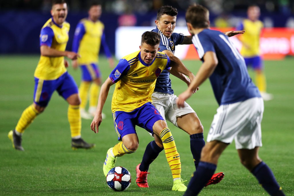 CARSON, CALIFORNIA - FEBRUARY 23: Cole Bassett #26 of the Colorado Rapids controls the ball against Servando Carrasco #6 of the Los Angeles Galaxy ...