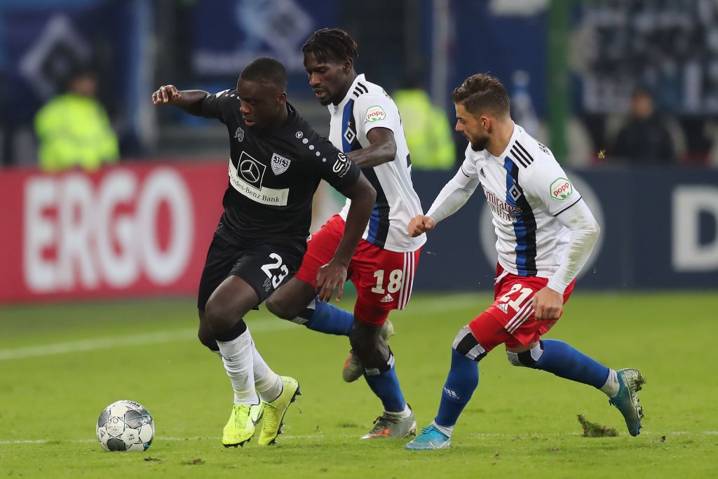 HAMBURG, GERMANY - OCTOBER 29: Orel Mangala of VfB Stuttgart is challenged by Bakery Jatta and Tim Leibold of Hamburger SV during the DFB Cup second round match between Hamburger SV and VfB Stuttgart at Volksparkstadion on October 29, 2019, in Hamburg, Germany. (Photo by Boris Streubel/Bongarts/Getty Images)