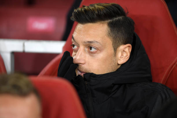 LONDON, ENGLAND - NOVEMBER 28: Mesut Ozil of Arsenal looks on from the substitute bench ahead of the UEFA Europa League group F match between Arsen...