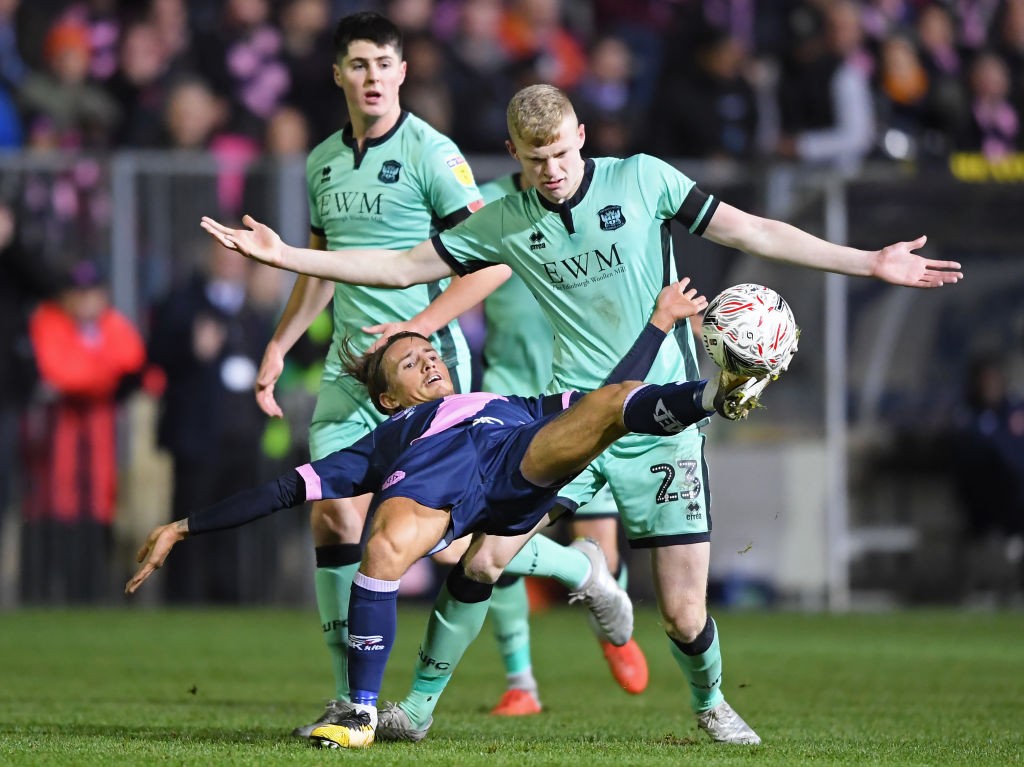 LONDON, ENGLAND - NOVEMBER 08: Ben Chapman of Dulwich Hamlet is challenged by Jarrad Branthwaite of Carlisle United during the FA Cup First Round m...