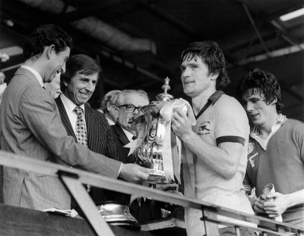 12th May 1979:  Prince Charles presenting Arsenal captain Pat Rice with the FA Cup after his team beat Manchester United 3-2. Frank Stapleton, who scored during the match, is behind him.  (Photo by Mike Stephens/Central Press/Getty Images)