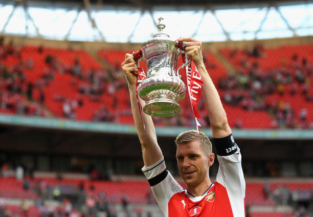 Arsenal man to remain as TV expert until after Euros 4 LONDON, ENGLAND - MAY 27: Per Mertesacker of Arsenal celebrates with the trophy after The Emirates FA Cup Final between Arsenal and Chelsea at Wembley Stadium on May 27, 2017 in London, England. (Photo by Laurence Griffiths/Getty Images)