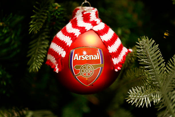 LONDON, ENGLAND - DECEMBER 03: An Arsenal Christmas bauble hangs on a Christmas tree in the club store before the Barclays Premier League match bet...
