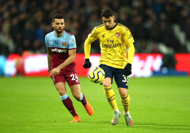 LONDON, ENGLAND - DECEMBER 09: Gabriel Martinelli of Arsenal is closed down by Ryan Fredricks of West Ham United during the Premier League match be...