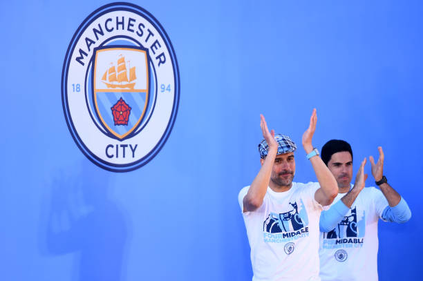 MANCHESTER, ENGLAND - MAY 20: Josep Guardiola, Manager of Manchester City and Mikel Arteta, Assistant Coach of Manchester City applaud fans during ...