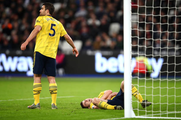 LONDON, ENGLAND - DECEMBER 09: Kieran Tierney of Arsenal reacts following an injury during the Premier League match between West Ham United and Arsenal FC at London Stadium on December 09, 2019 in London, United Kingdom. (Photo by Julian Finney/Getty Images)