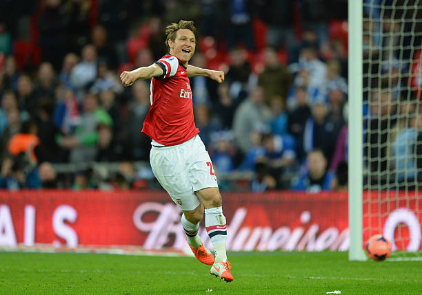 LONDON, ENGLAND - APRIL 12: Kim Kallstrom of Arsenal celebrates scoring in the penalty shoot during the FA Cup Semi-Final match between Wigan Athle...