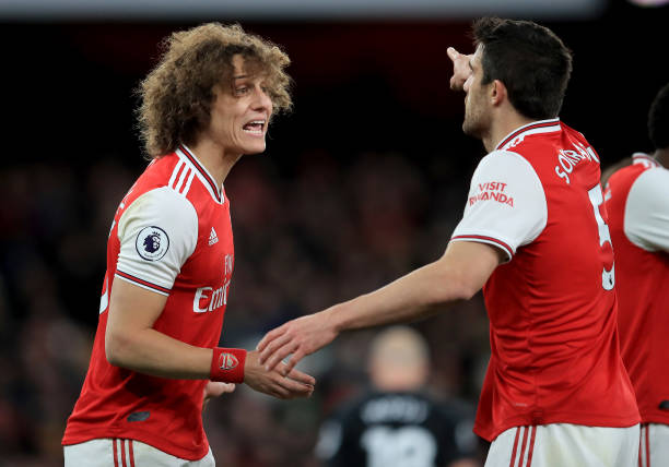 LONDON, ENGLAND - DECEMBER 05: David Luiz of Arsenal discusses with Sokratis of Arsenal during the Premier League match between Arsenal FC and Brighton & Hove Albion at Emirates Stadium on December 05, 2019 in London, United Kingdom. (Photo by Marc Atkins/Getty Images)