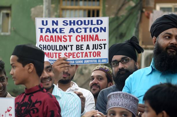 Indian Muslims hold placards as they protest to denounce the Chinese government's policies for Uighur Muslims in Xinjiang, in Mumbai on December 9,...
