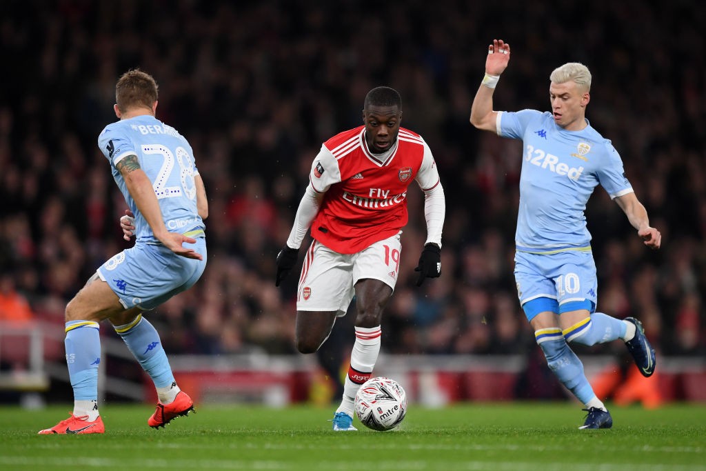 LONDON, ENGLAND - JANUARY 06: Nicolas Pepe of Arsenal takes on Gaetano Berardi and Ezgjan Alioski of Leeds United during the FA Cup Third Round match between Arsenal FC and Leeds United at the Emirates Stadium on January 06, 2020, in London, England. (Photo by Shaun Botterill/Getty Images)