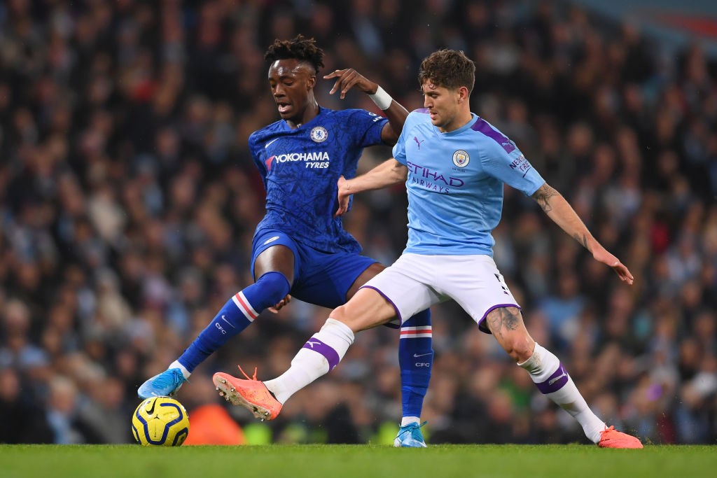 MANCHESTER, ENGLAND - NOVEMBER 23: Tammy Abraham of Chelsea battles with John Stones of Manchester City during the Premier League match between Man...