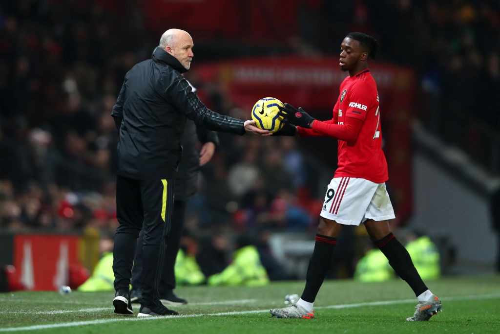 MANCHESTER, ENGLAND - DECEMBER 26: Mike Phelan, Assistant Manager of Manchester United passes the ball to Aaron Wan-Bissaka of Manchester United during the Premier League match between Manchester United and Newcastle United at Old Trafford on December 26, 2019, in Manchester, United Kingdom. (Photo by Clive Brunskill/Getty Images)